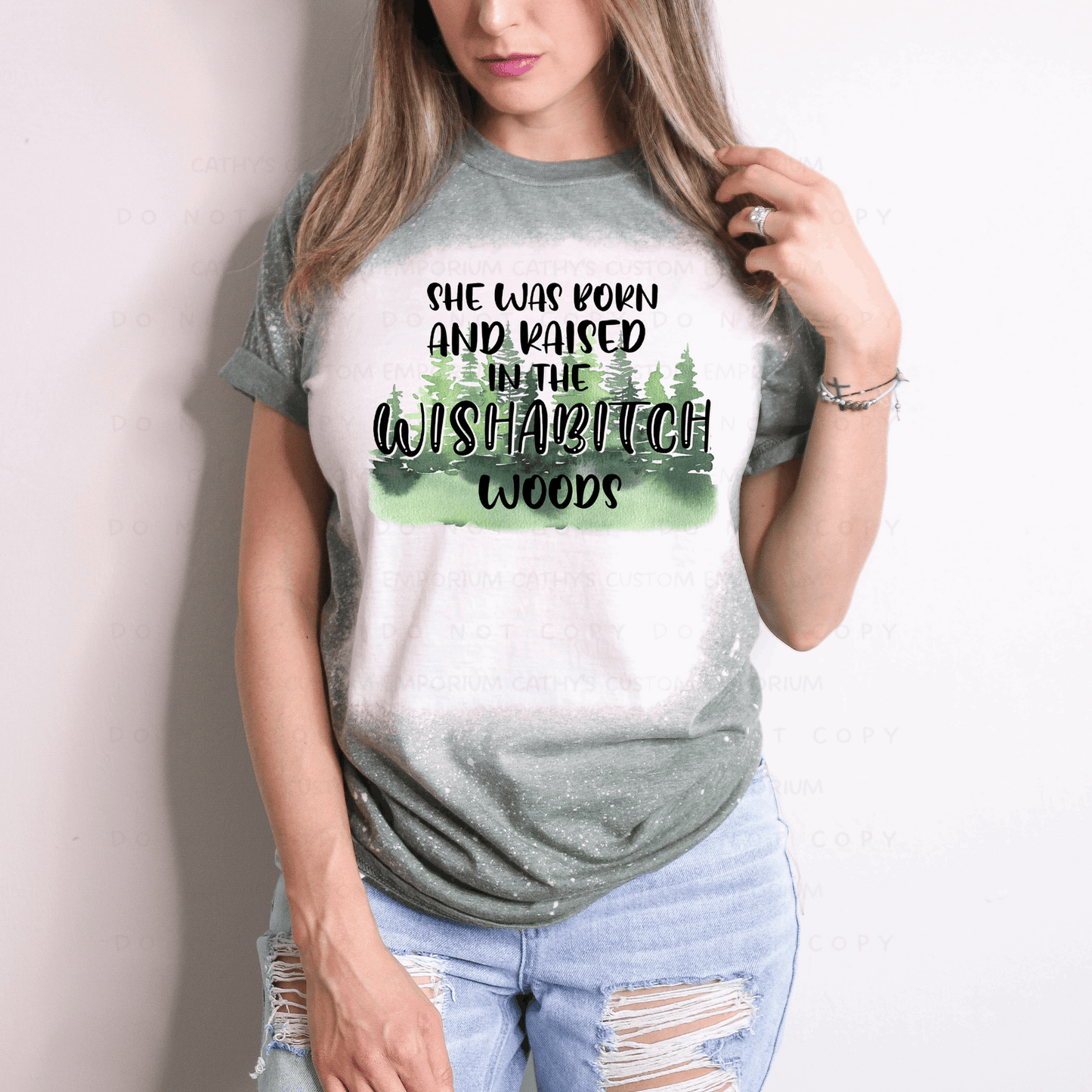 funny, sassy, and confident Gildan 65/35 poly cotton blend unisex green graphic t-shirt. Reads Born and Raised in Wishabitch Woods.