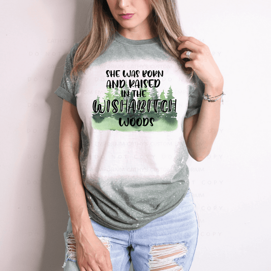 funny, sassy, and confident Gildan 65/35 poly cotton blend unisex green graphic t-shirt. Reads Born and Raised in Wishabitch Woods.