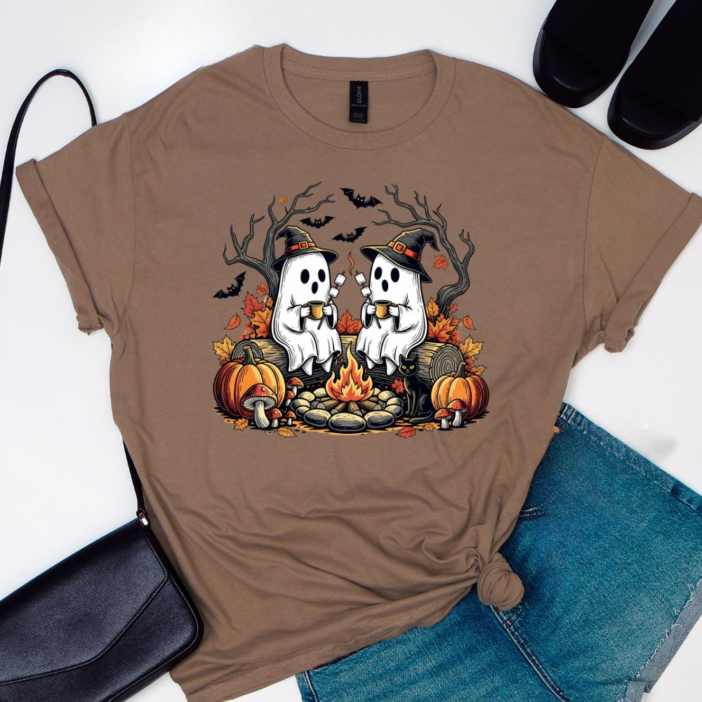 Brown t-shirt with Halloween-themed design featuring ghosts, pumpkins, and a bonfire.