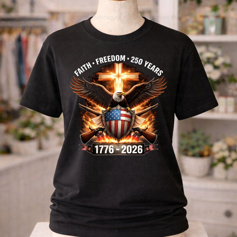 Black t-shirt with eagle, cross, and American flag design on a mannequin in a store setting.