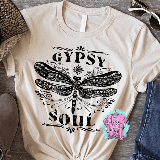 Beige T-shirt with "Gypsy Soul" printed in black, featuring an intricate dragonfly design with detailed boho-style patterns.