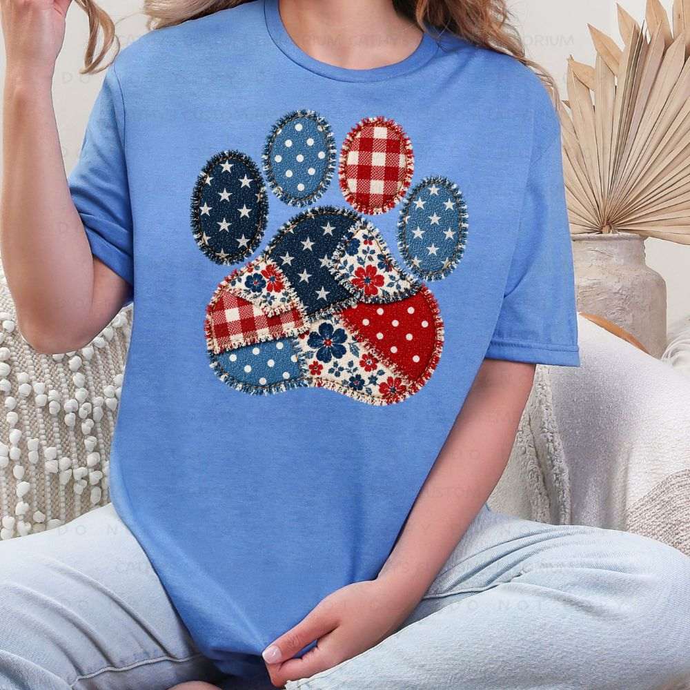 Blue patriotic graphic T-shirt with red white and blue patchwork paw print design