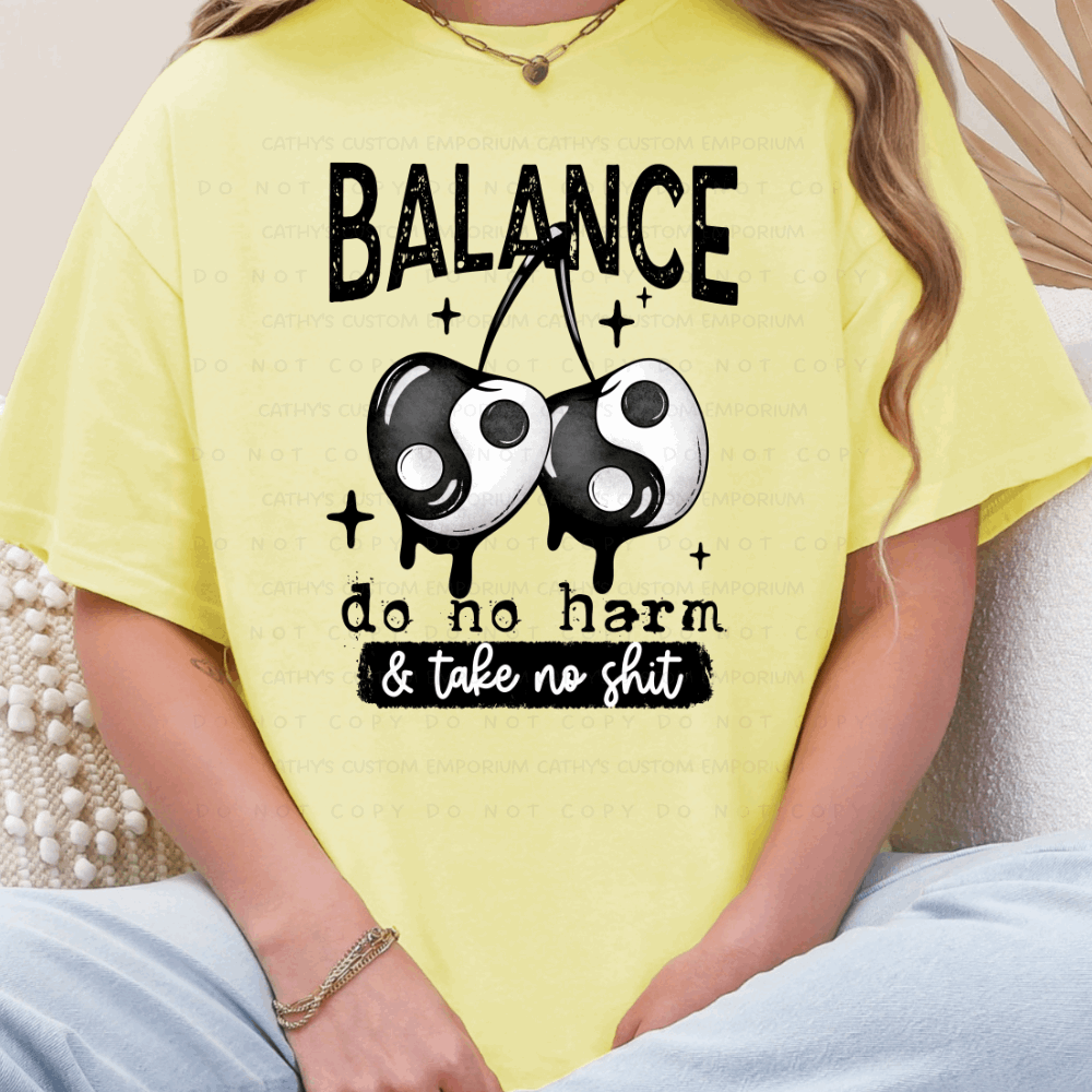 yellow graphic T-shirt with balance do no harm take no shit design with yin yang cherries