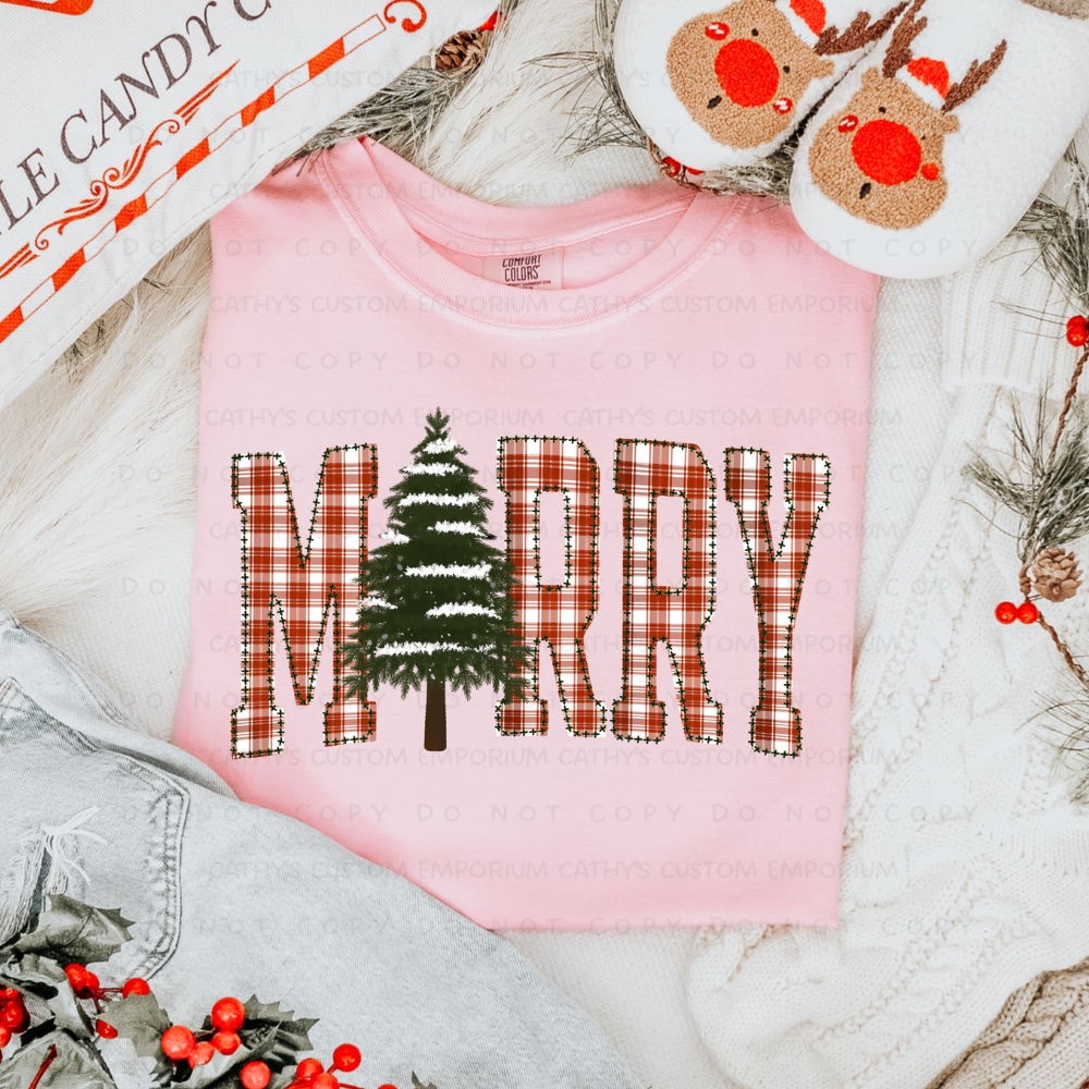 Plaid Merry Christmas tree graphic shown on a light pink Comfort Colors shirt