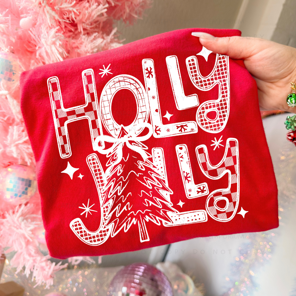 White retro Holly Jolly Christmas tree graphic shown on a bright red garment