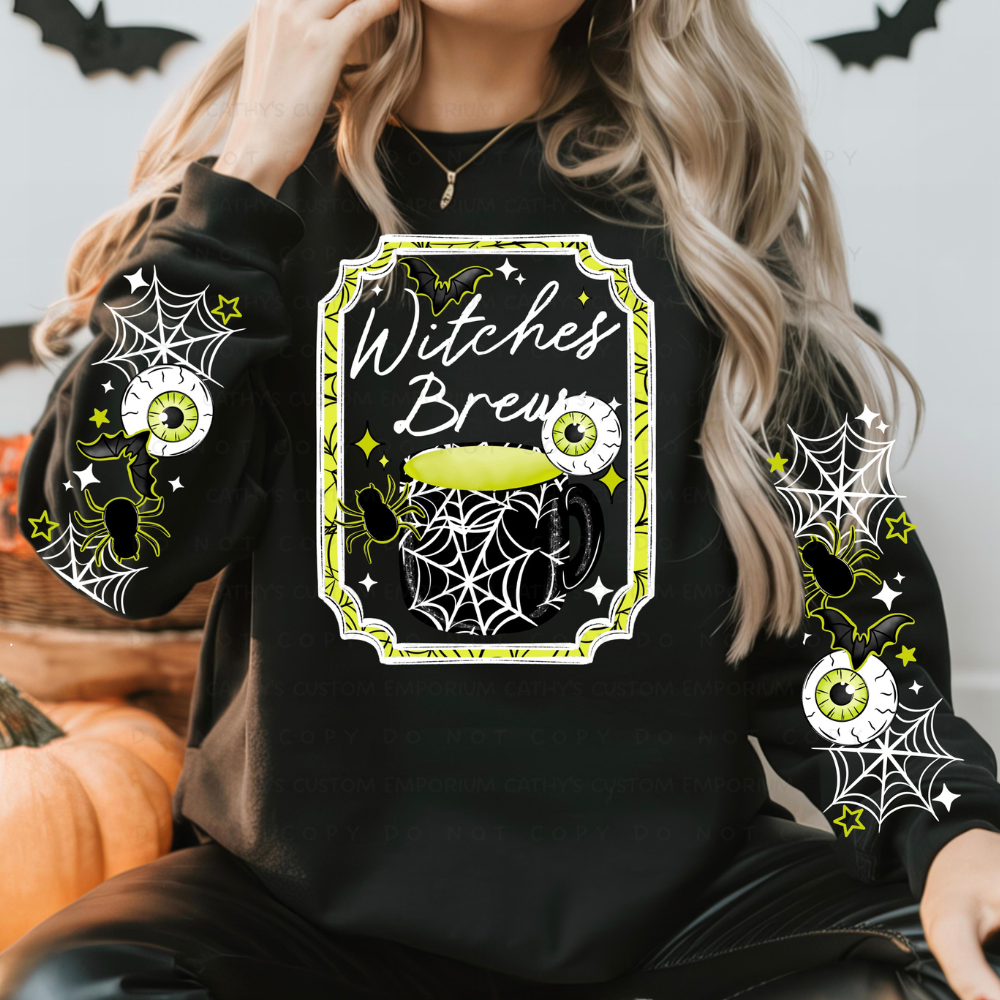 Woman wearing a black Witches Brew Halloween sweatshirt with a lime green cauldron, eyeballs, bats, spiders, webs, and coordinating sleeve designs