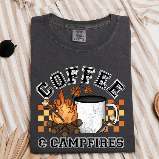 Coffee & Campfires graphic apparel shown on Comfort Colors Pepper featuring a campfire, coffee mug, marshmallows, and fall accents.