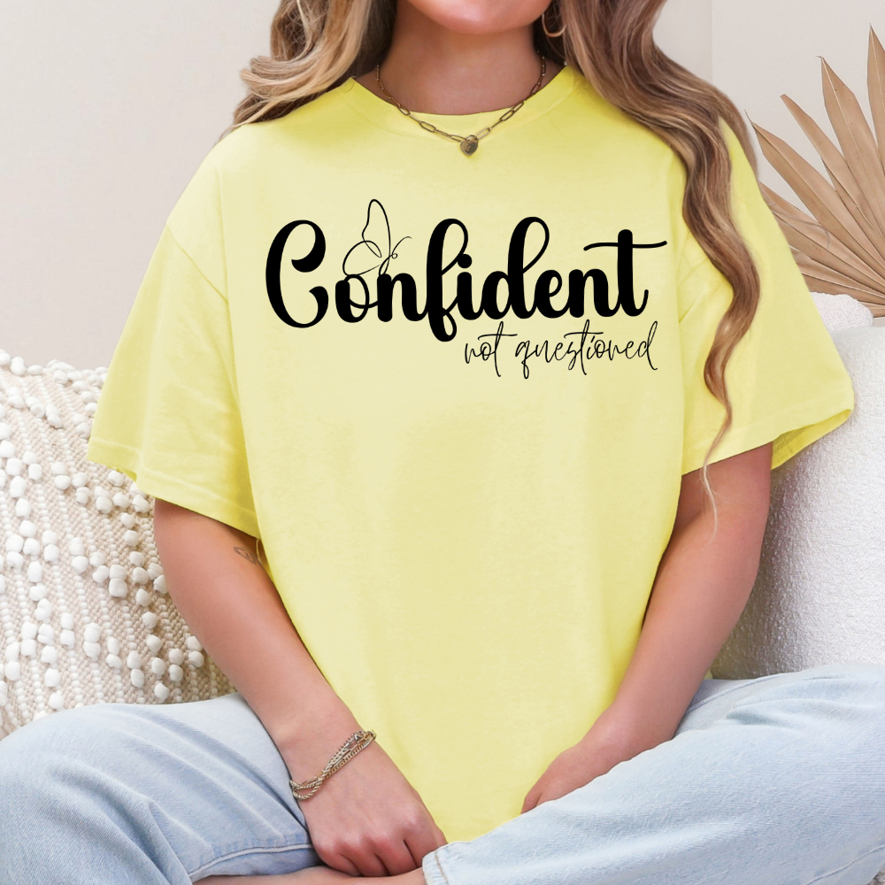 Confident Not Questioned inspirational graphic T-shirt printed on a Corn Silk Gildan Softstyle shirt.