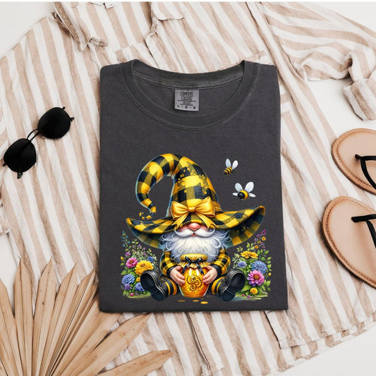 Charcoal gray t-shirt with gnome in yellow hat holding honey jar, bees flying, and flowers around.

