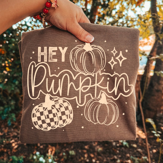 Hey Pumpkin graphic apparel featuring a vintage pickup truck filled with pumpkins and fall accents shown on a Comfort Colors Espresso