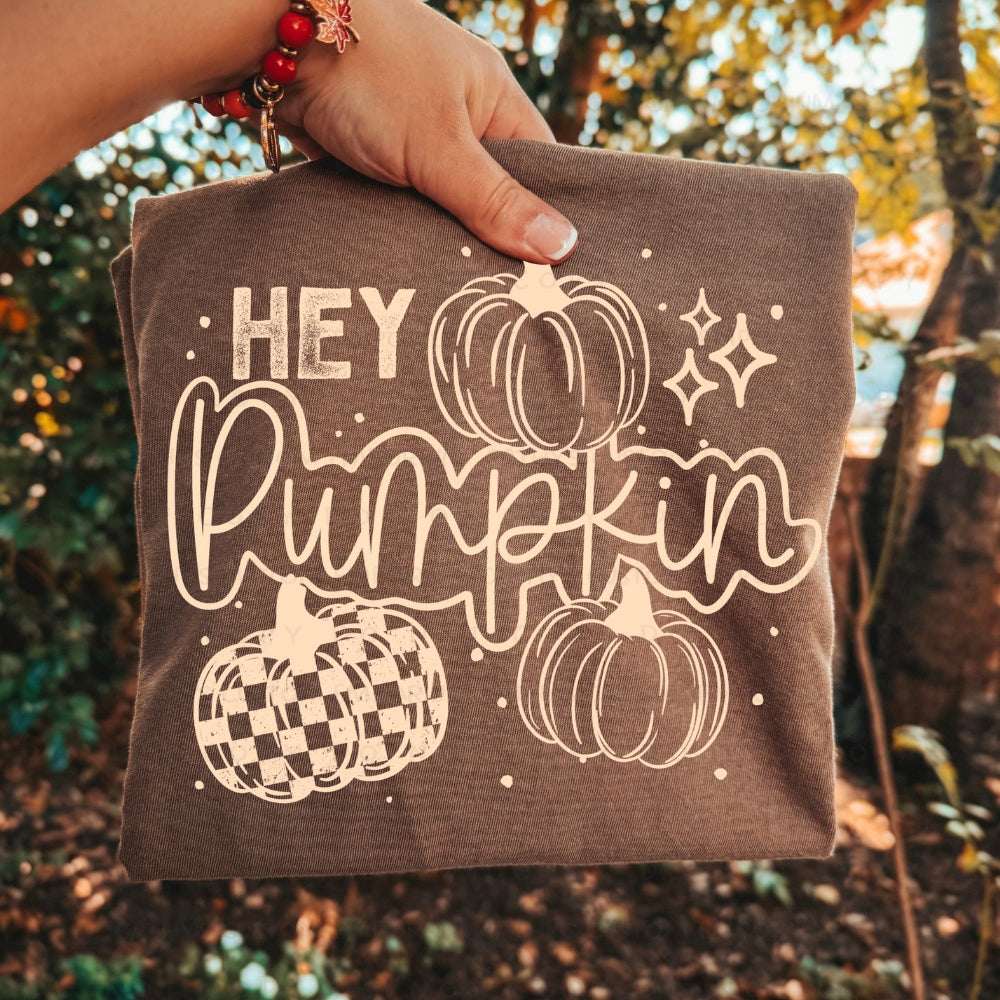 Hey Pumpkin graphic apparel featuring a vintage pickup truck filled with pumpkins and fall accents shown on a Comfort Colors Espresso