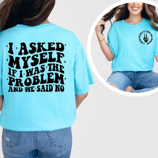 Bright blue t-shirt with bold black text on back reading “I Asked Myself If I Was the Problem and We Said No” and small matching front design.

