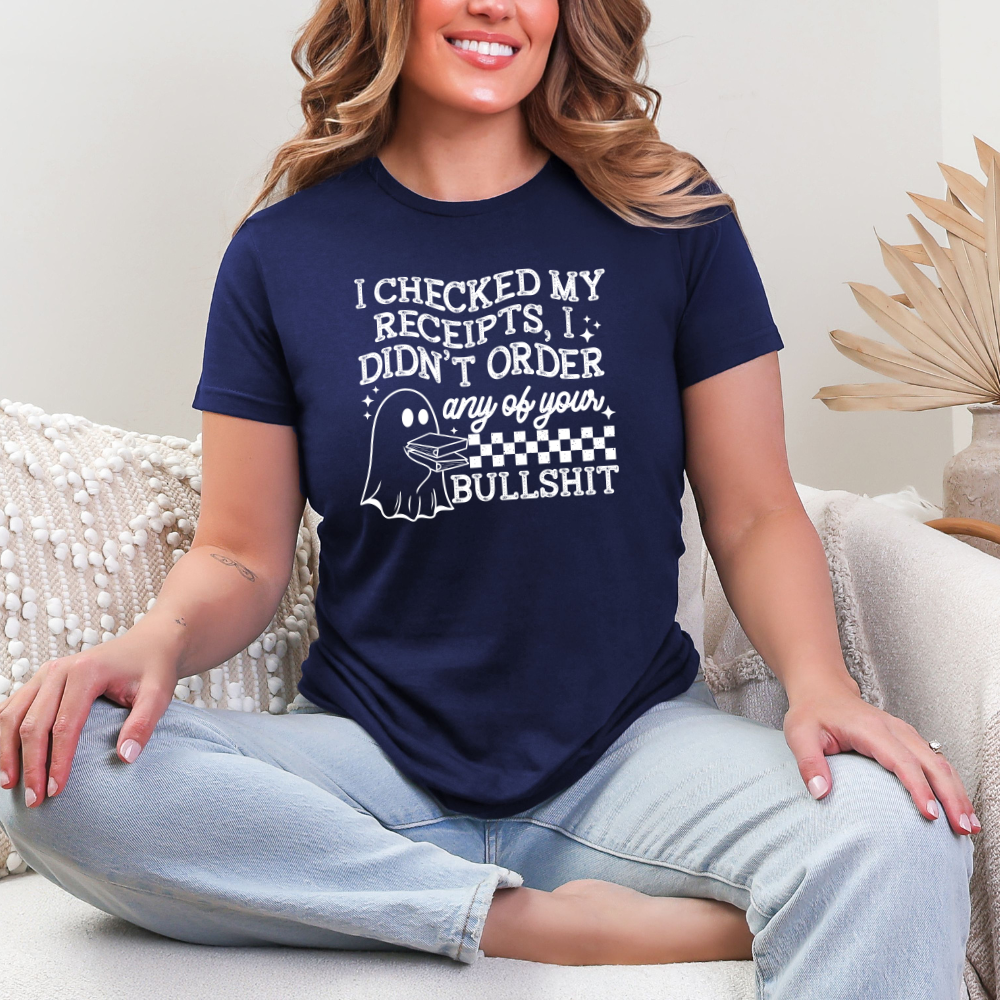 Woman wearing a navy Graphic T-Shirt with a white I Checked My Receipts ghost design