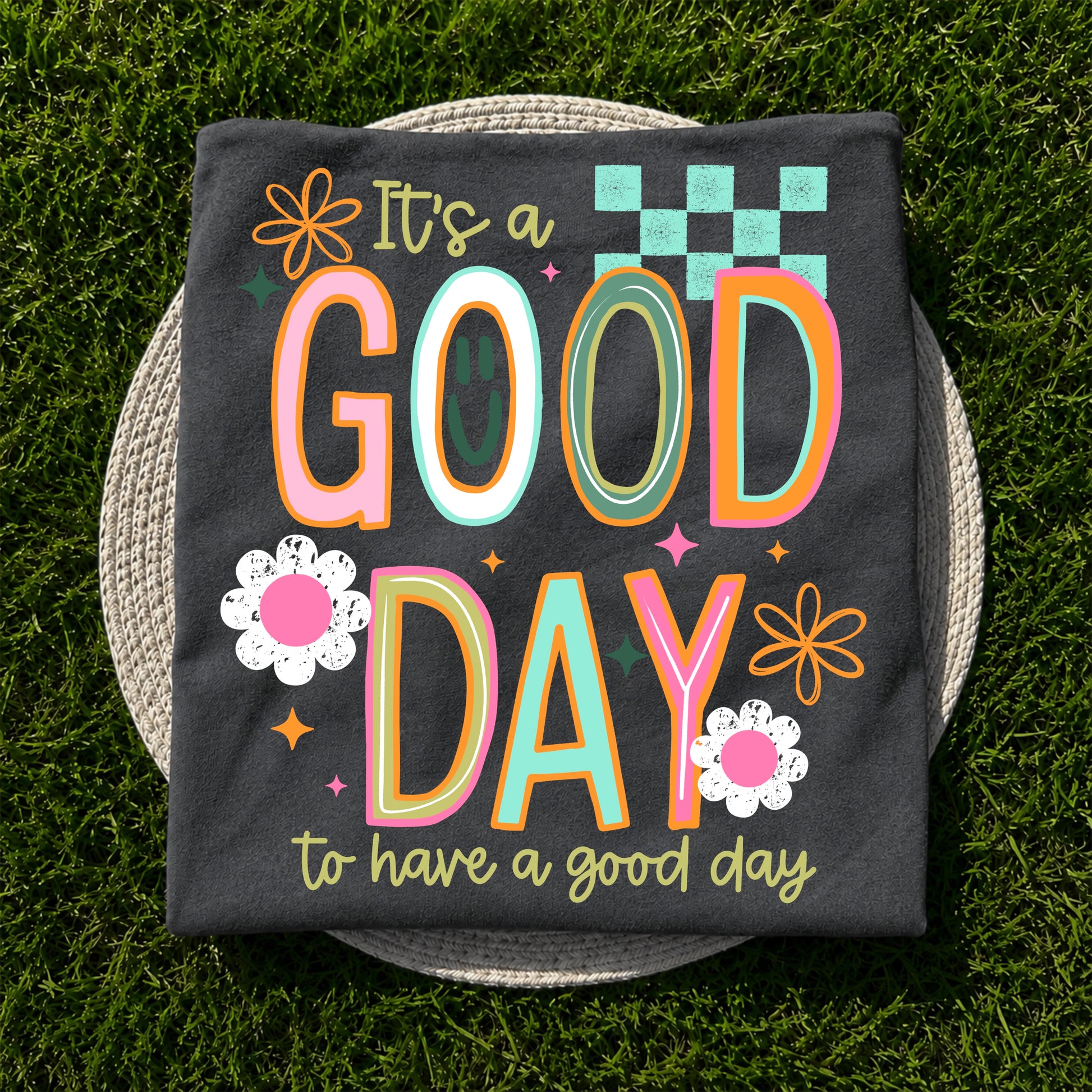 It's a Good Day to Have a Good Day graphic apparel on Comfort Colors Pepper featuring colorful retro lettering and floral accents.