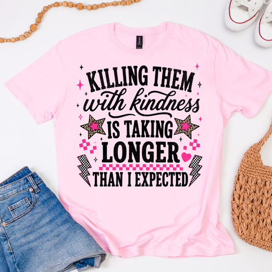 Gildan Softstyle Light Pink graphic T-shirt featuring Killing Them With Kindness Is Taking Longer Than Expected in black and hot pink.
