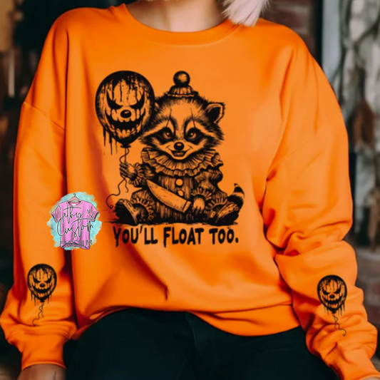 Eerie Clown Raccoon Holding a knife and a balloon with a with a clown face, on a soft orange sweatshirt. Each sleeve has a balloon that matches the one the clown is holding.