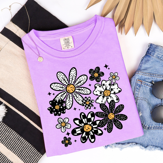 Retro Pattern Flower graphic t-shirt displayed on a Comfort Colors Orchid shirt featuring black and white patterned flowers.