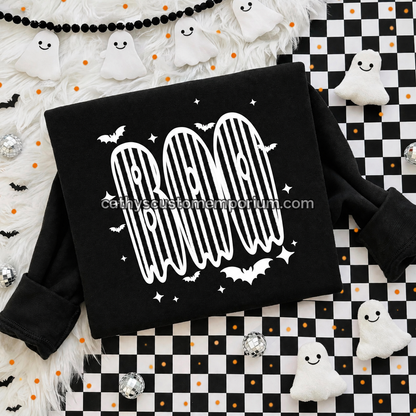 Black BOO Halloween sweatshirt with white striped ghost lettering and bat accents on a checkered flat lay