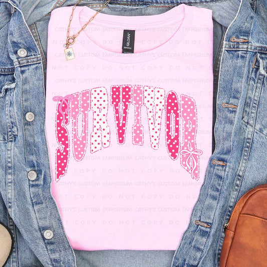 Light pink shirt featuring the word Survivor in pink and white polka-dot lettering with delicate bow accents for breast cancer awareness.