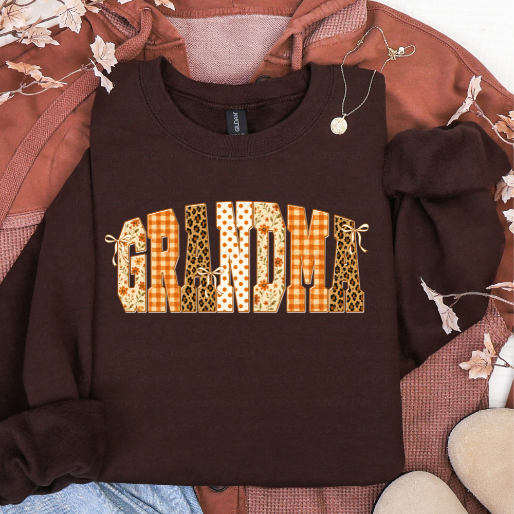 Brown sweatshirt featuring GRANDMA in floral, orange plaid, leopard print, and polka dot fall patterns