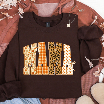 Brown sweatshirt featuring MAMA in floral, orange plaid, leopard print, and polka dot fall patterns
