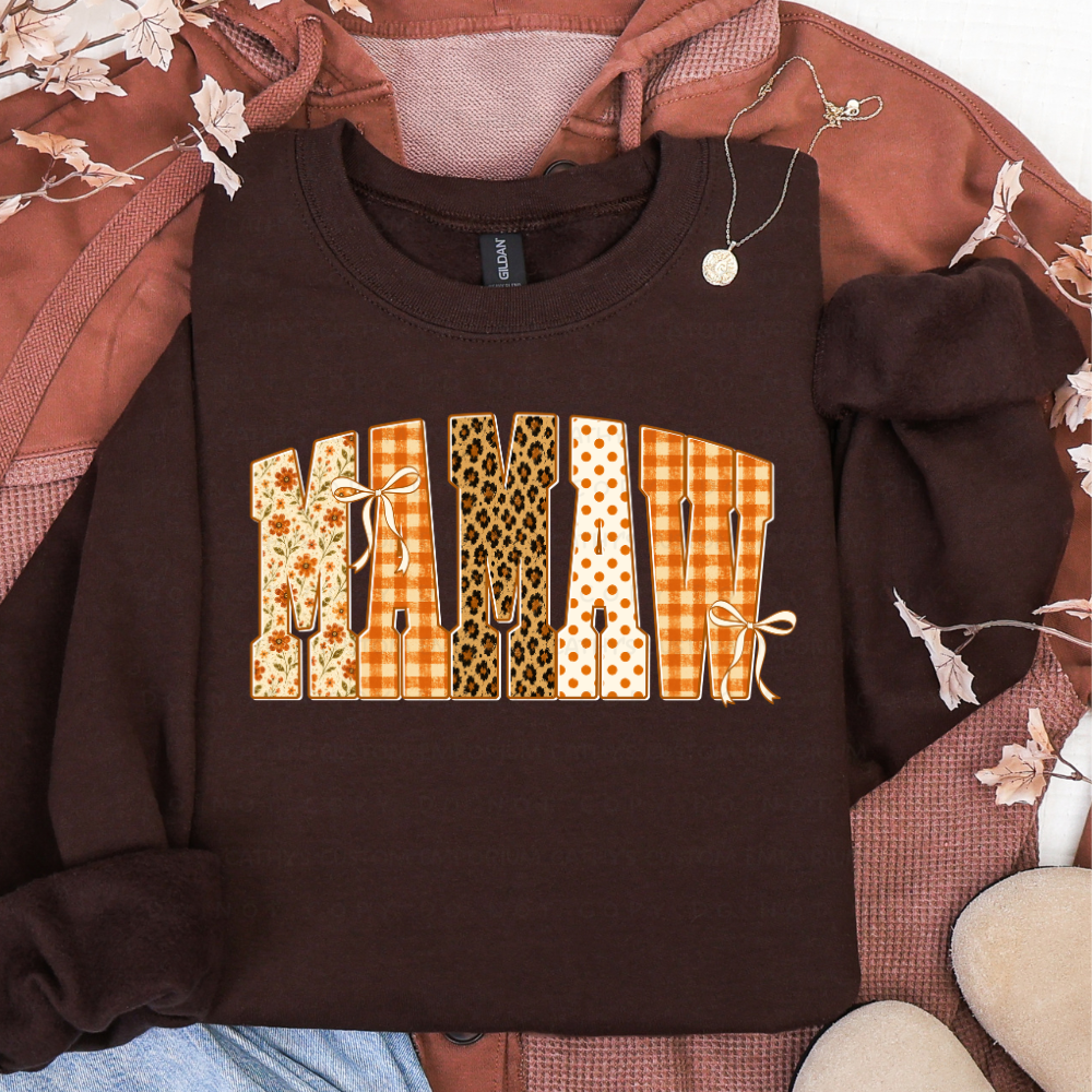 Brown sweatshirt featuring MAMAW in floral, orange plaid, leopard print, and polka dot fall patterns