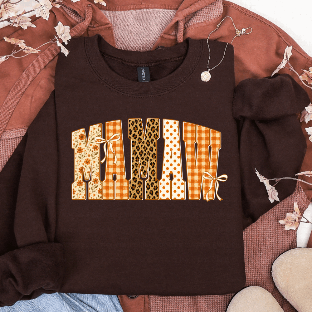 Brown sweatshirt featuring MAMAW in floral, orange plaid, leopard print, and polka dot fall patterns