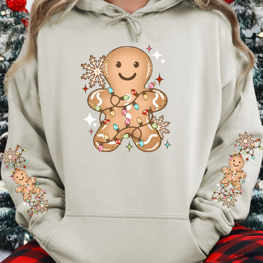 Beige hoodie with a gingerbread man tangled in Christmas lights design.