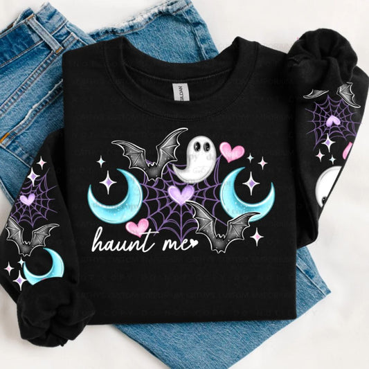 Black folded Halloween sweatshirt with a Haunt Me ghost, bats, crescent moons, hearts, sparkles, and coordinating sleeve artwork