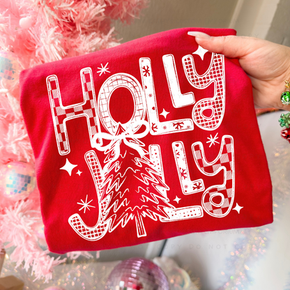 White retro Holly Jolly Christmas tree graphic shown on a bright red garment