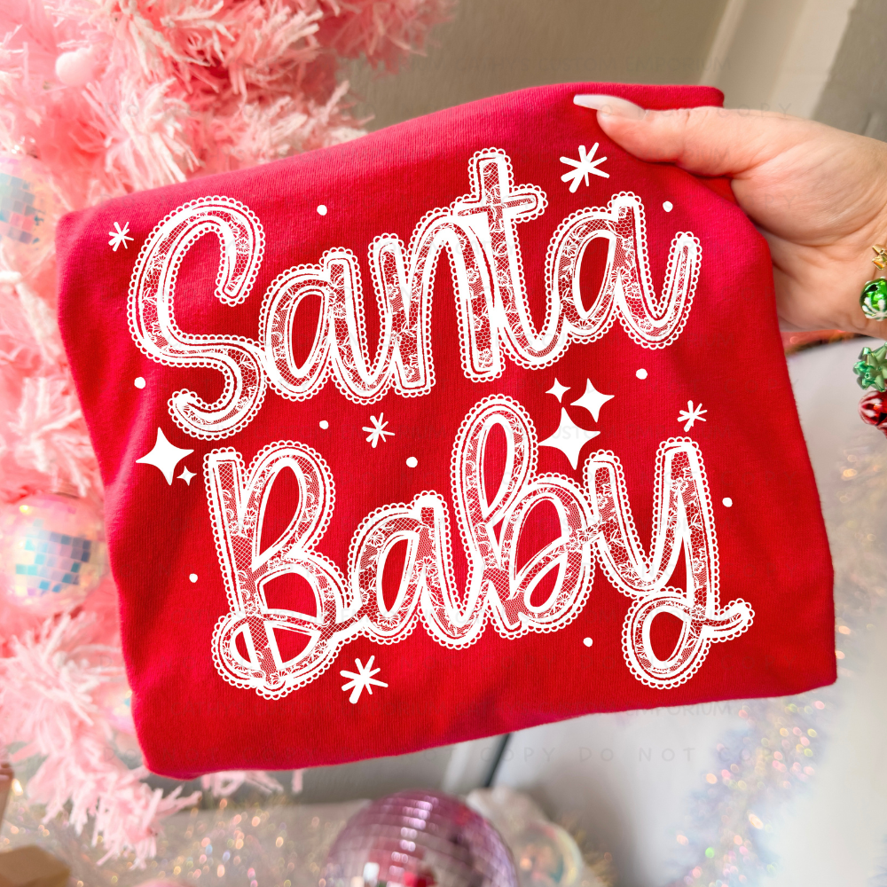 White lace Santa Baby Christmas graphic shown on a bright red garment