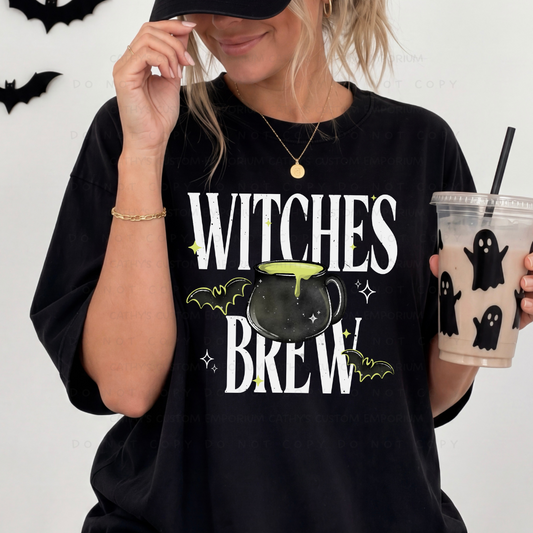 Woman wearing a black Witches Brew Halloween graphic shirt with a bubbling cauldron, bats, and lime green accents